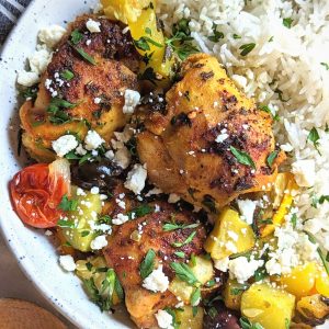mediterranean chicken rice bowl recipe with roasted vegetables and feta cheese over rice