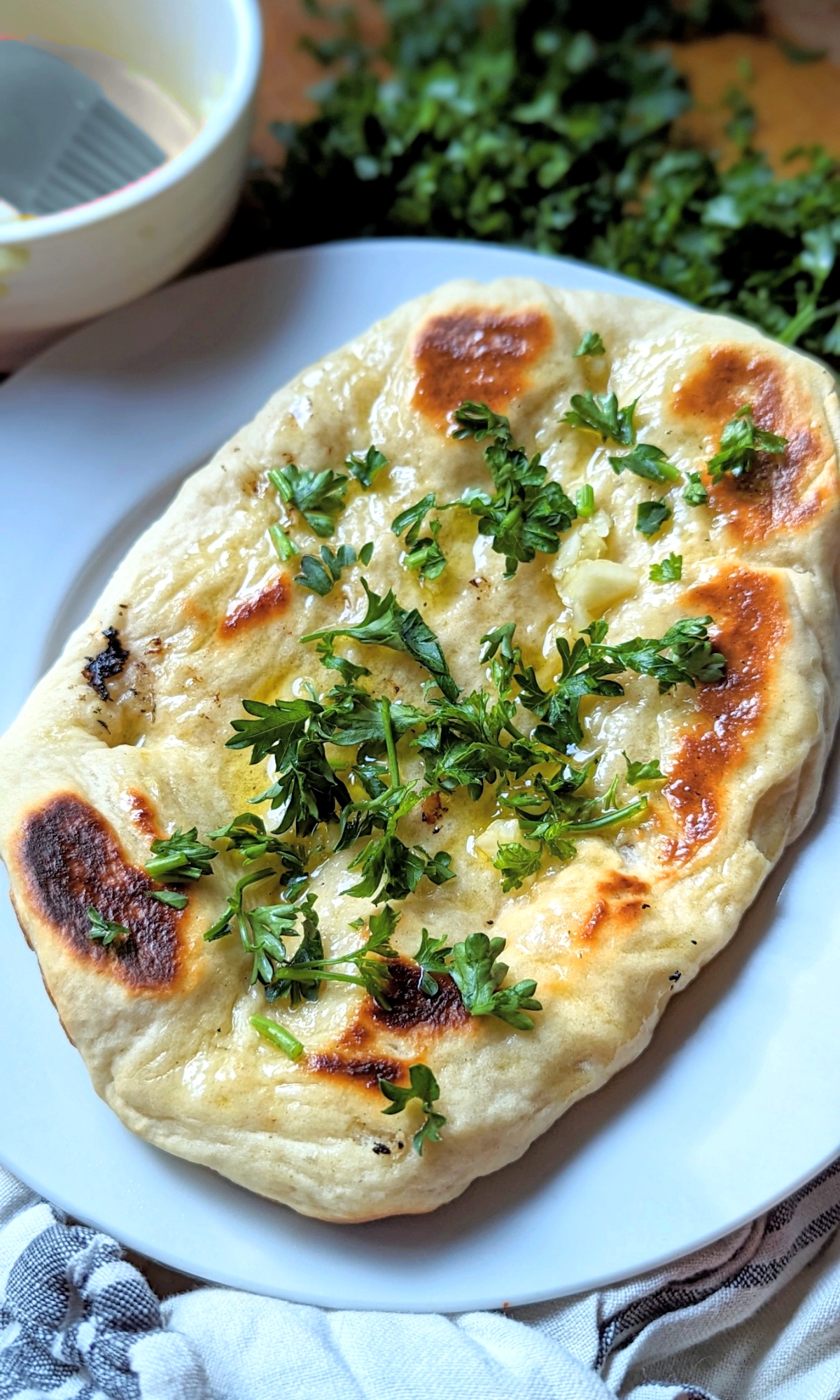 naan on the grill easy big green egg breads recipes naan bread with yogurt garlic olive oil and parsley on top