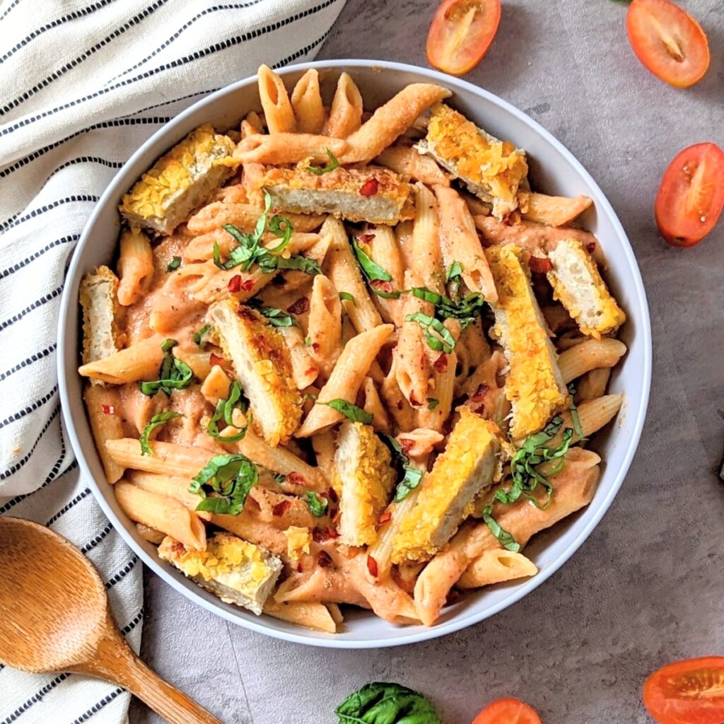 chicken alla vodka penne pasta recipe with breaded chicken in a bowl with noodles tomatoes and herbs in a creamy sauce