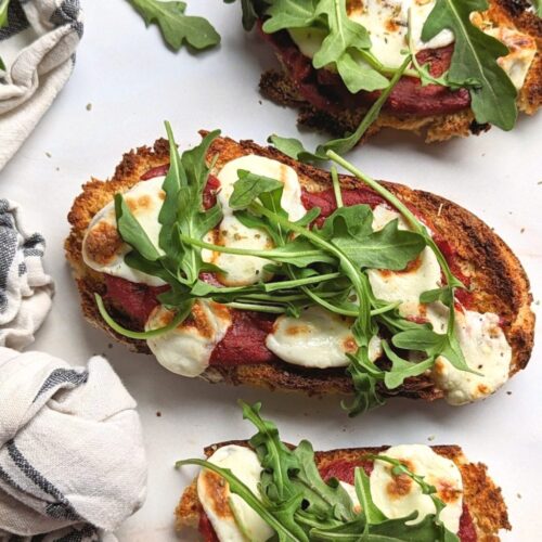 viral pizza toast recipe with tomatoes fresh mozzarella cheese basil and arugula on homemade beer bread toast