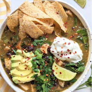 vegan chicken tortilla soup recipe with avocado red pepper flakes lime juice and plant based sour cream