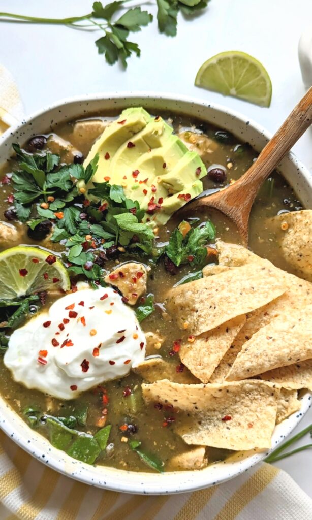 vegan tortilla soup with crispy tortilla chips tofu black beans red chili flakes and vegan coconut cream