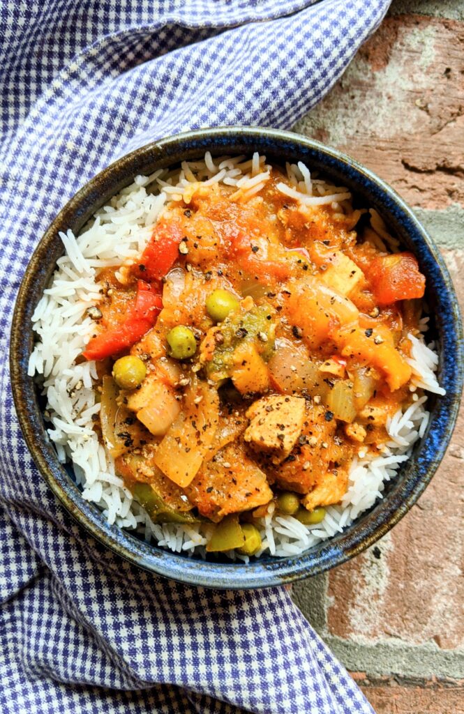 bowl of indian chicken dopiaza curry over basmati rice