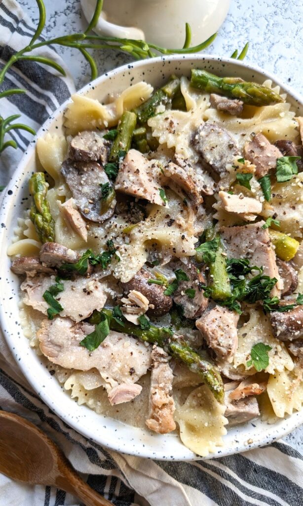 jerk chicken pasta with a creamy parmesan alfredo sauce with mushrooms and asparagus and bow tie pasta farfalle noodles
