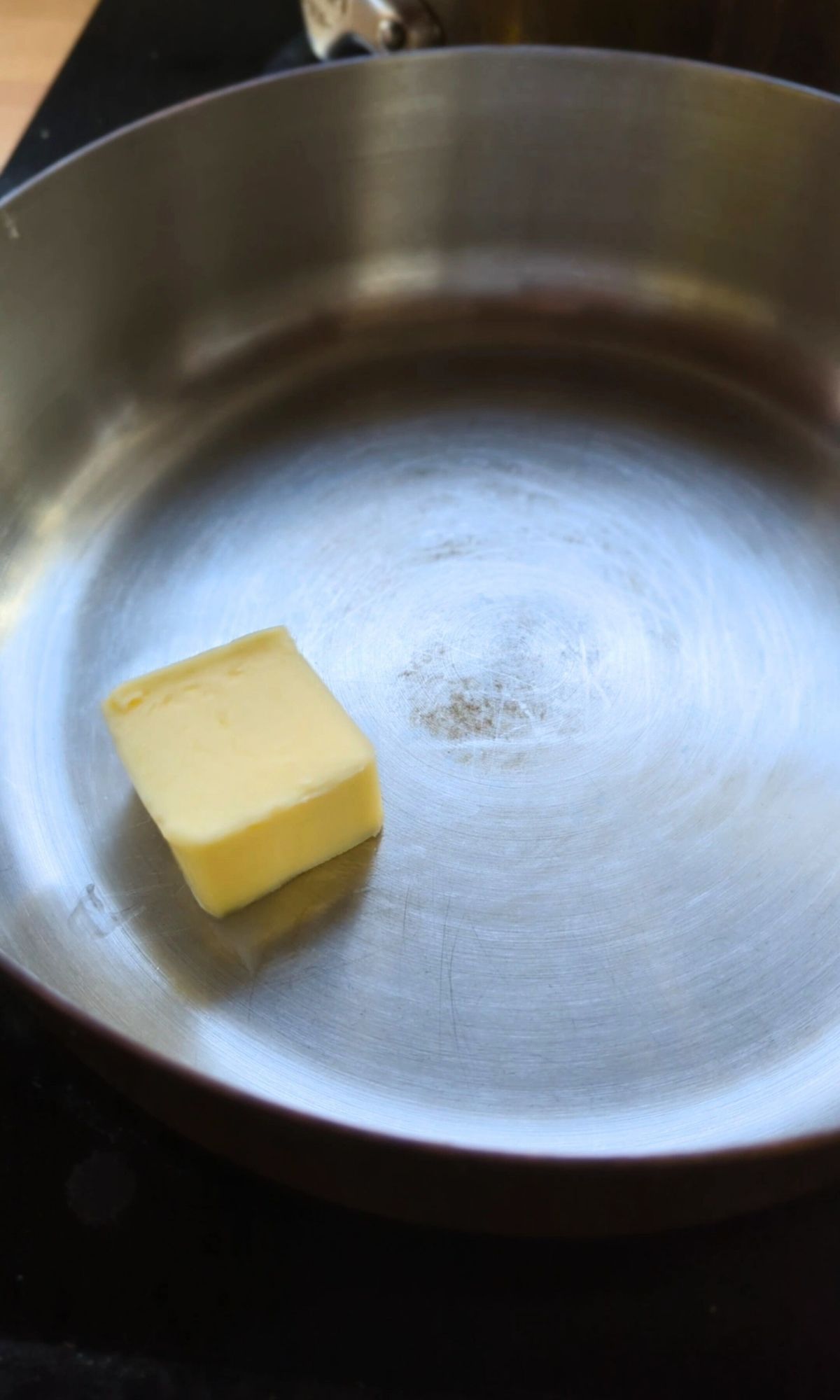 butter being melted into a pot.