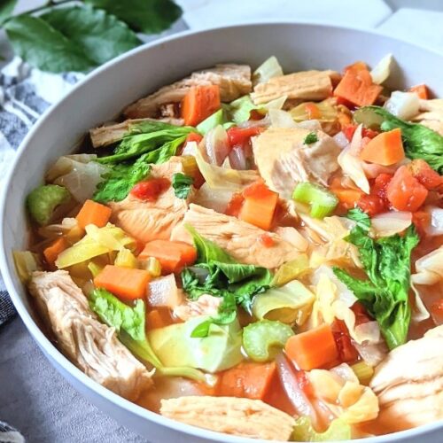 cabbage and chicken soup in a bowl with fresh vegetables.