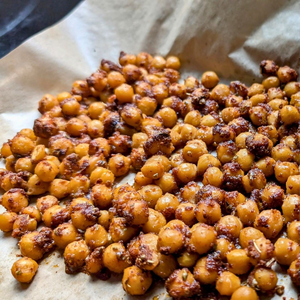 baked shawarma chickpeas ready for a pita wrap with veggies.