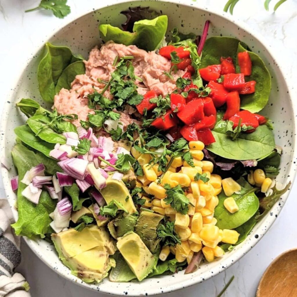 low carb and keto mexican tuna salad with lettuce, corn, avocado, and roasted red peppers.