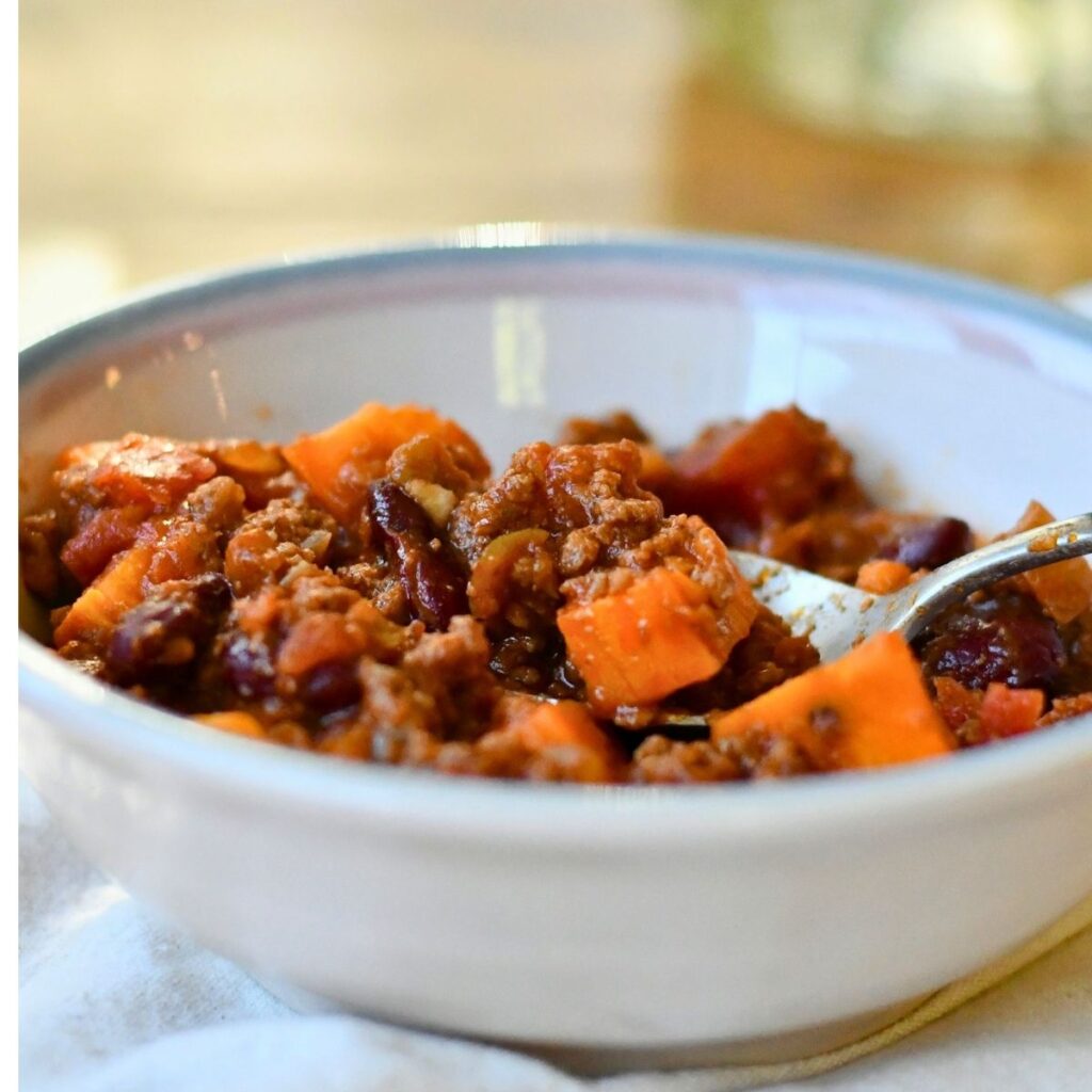 turkey and butternut squash chili with bell peppers onions garlic and spice.