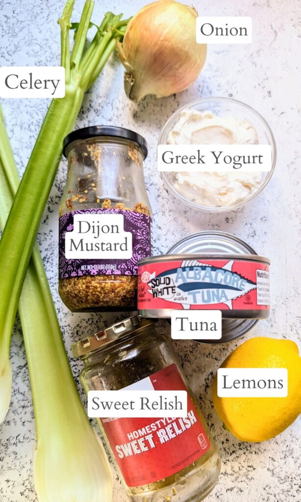 ingredients for greek yogurt tuna salad like celery, lemon juice, mayo, and canned tuna.