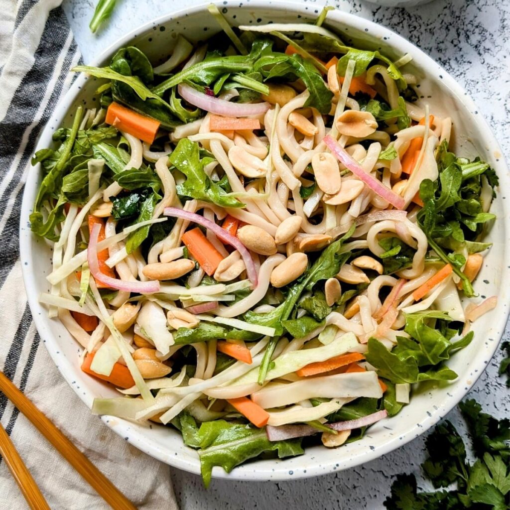 a large bowl of trader joe's thai wheat noodle salad to be eaten by chopsticks.