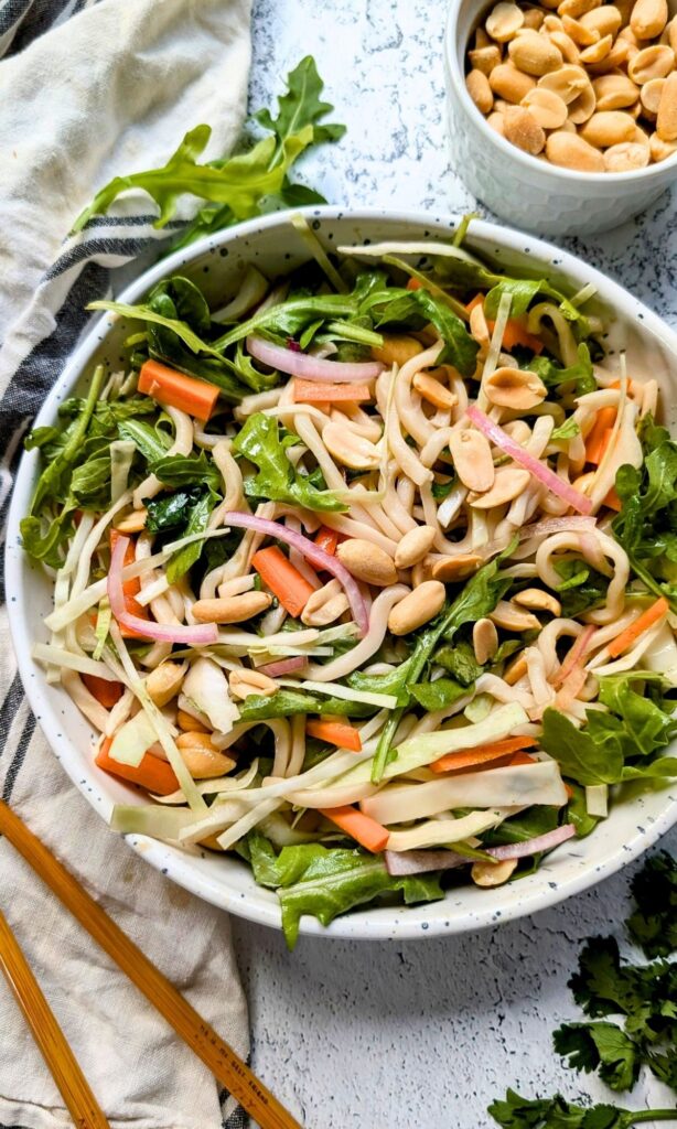 trader joe's thai wheat noodle recipes with cabbage, arugula, and a tangy sesame lime dressing.