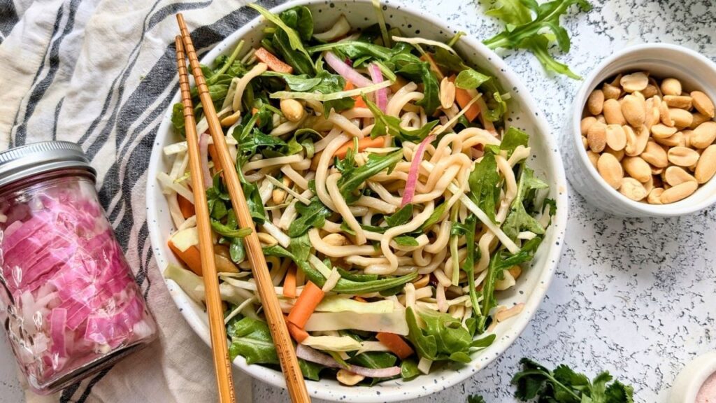 pickled onions, Thai noodle salad, and peanuts on the counter for a tasty lunch or dinner idea with trader joes thai wheat noodles.