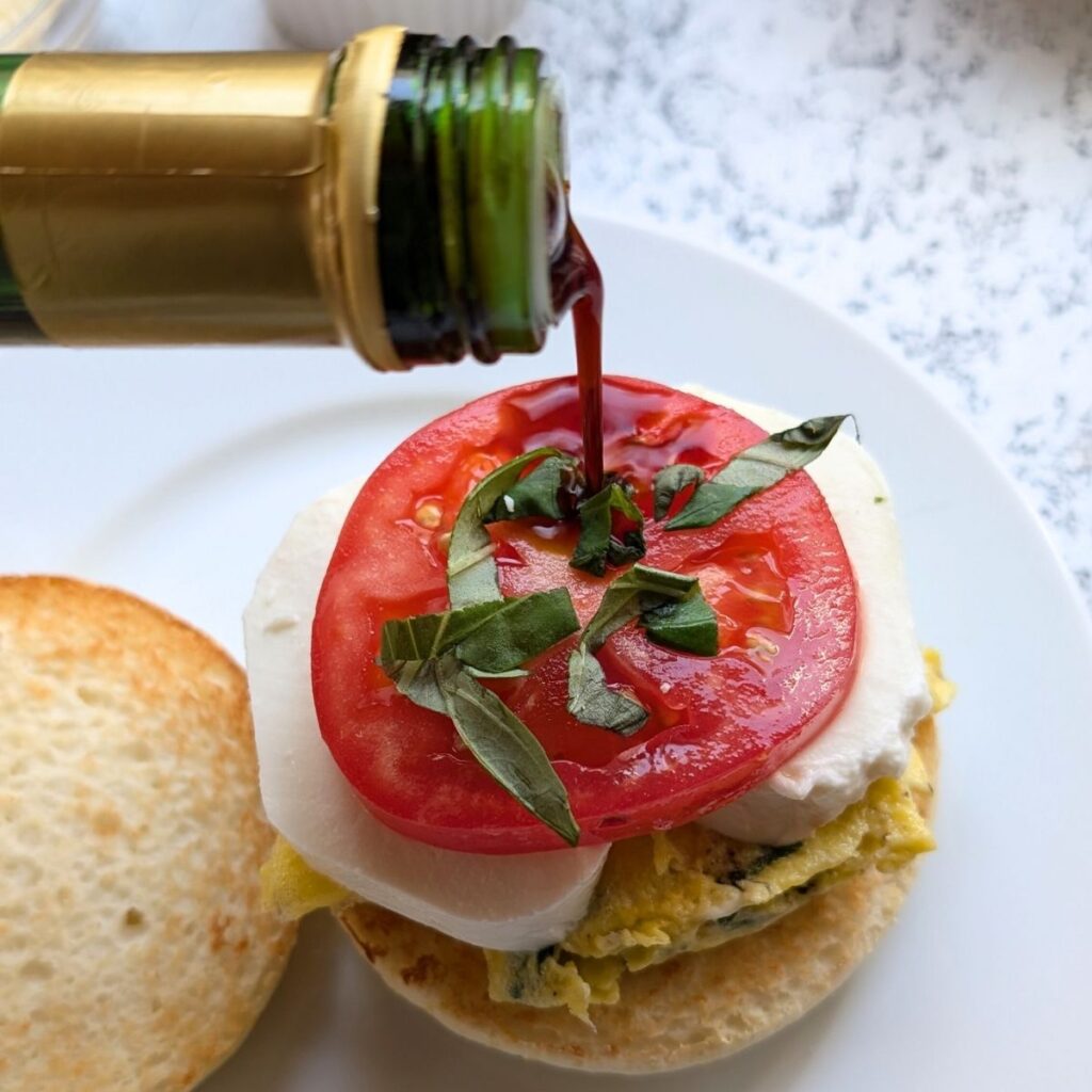 italian egg sandwich with tomatoes, mozzarella cheese, fresh basil, and balsamic vinegar.