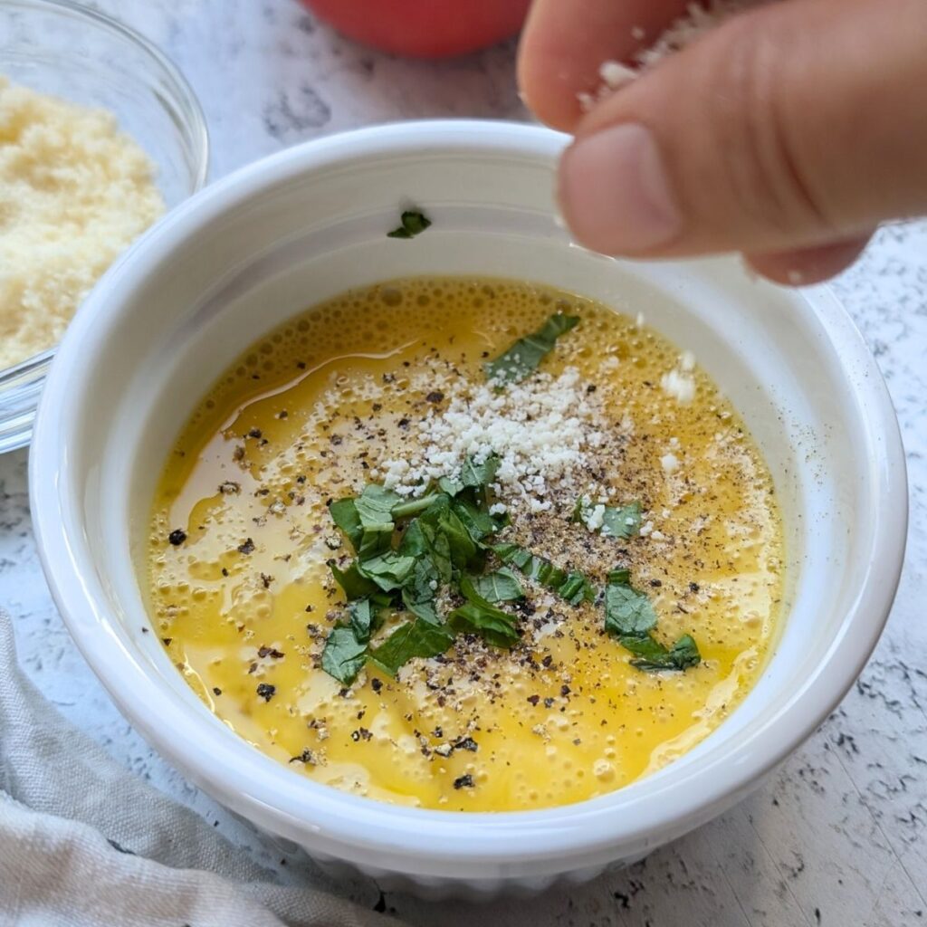 in a small dish, scramble your eggs, and add in the fresh basil and parmesan cheese.