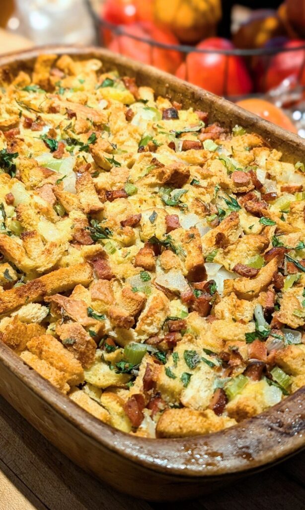 a baking dish of stuffing with chorizo sausage and vegetables.