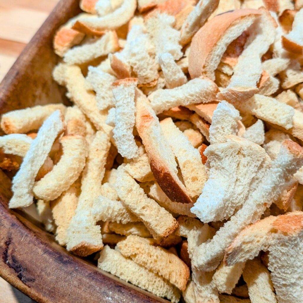 a baking dish with stale bread cubes or croutons for chorizo stuffing