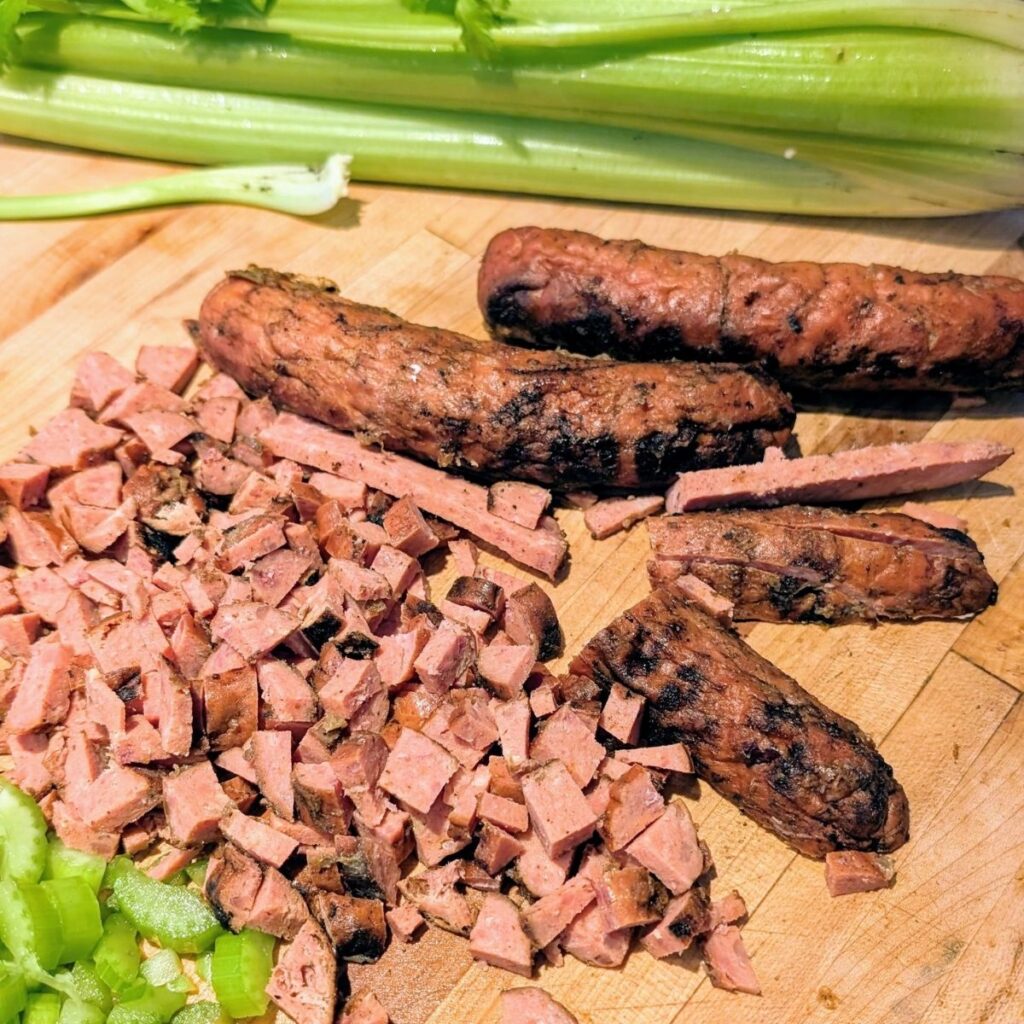 chopped chorizo sausage with celery on a cutting board waiting to make stuffing for thanksgiving.