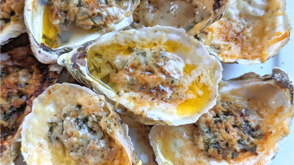 buttery baked oysters on the half shell with parmesan cheese and butter