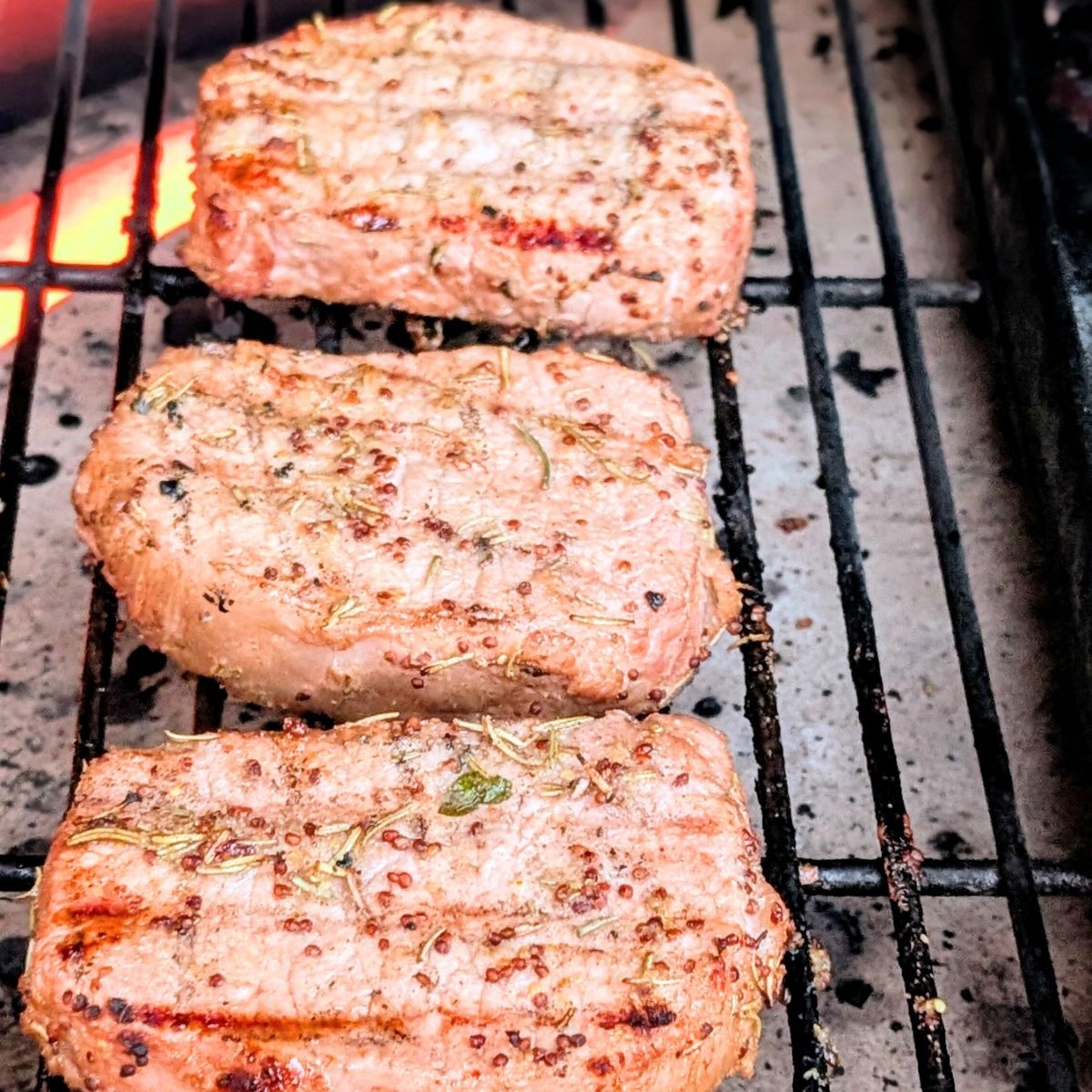 the big green egg grilling pork chops with the heat deflector and coals