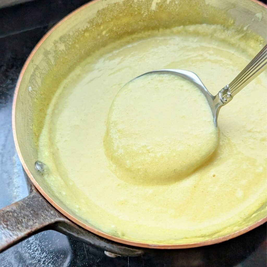 a ladle with Hollandaise sauce and mustard and turmeric and yogurt no eggs