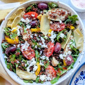 a rainbow greek quinoa salad with mediterranean vegetables and olives and vinaigrette