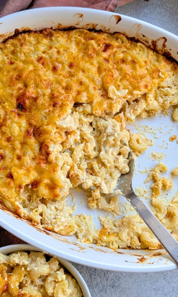 a spoon serving creamy baked ricotta pasta in a dish for dinner