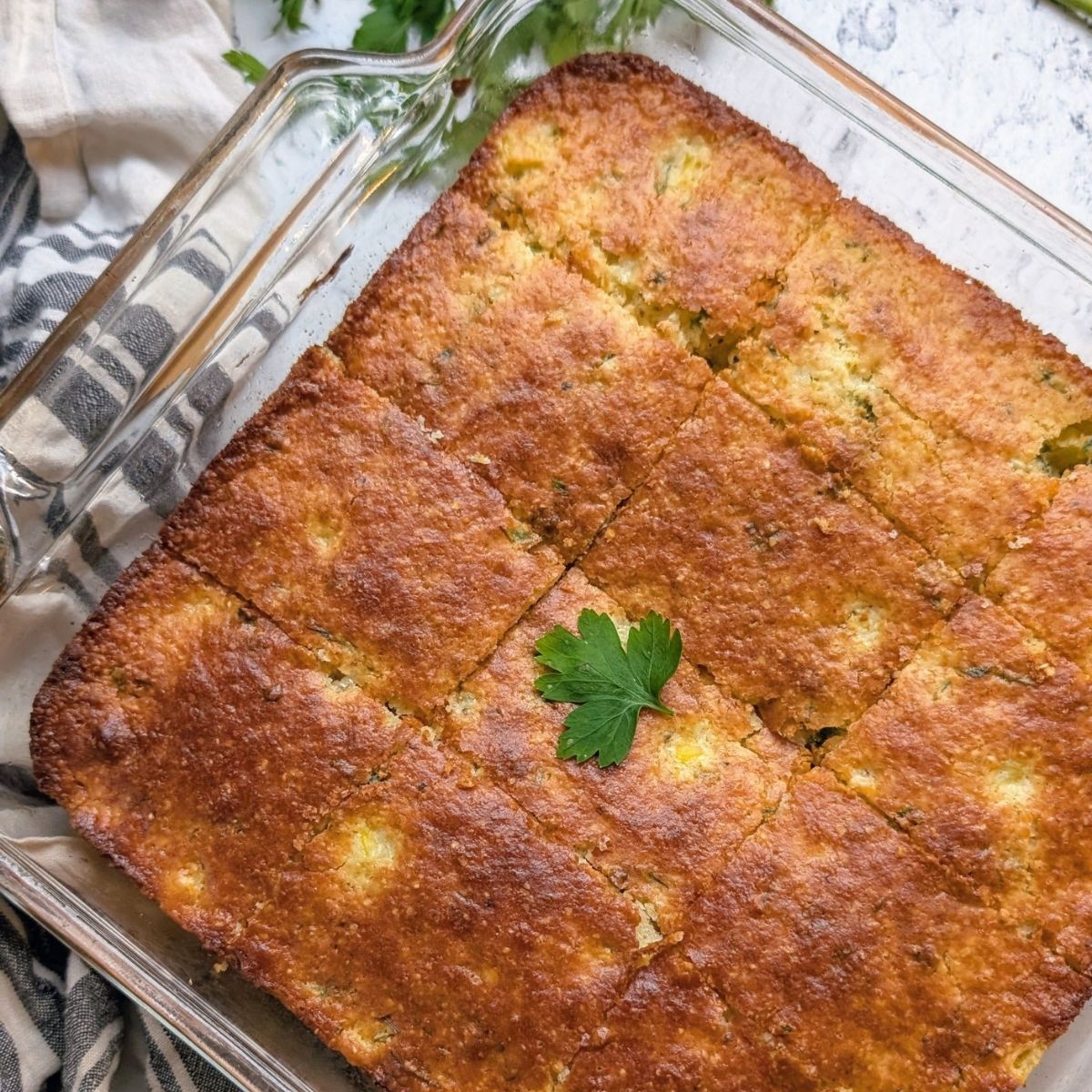 coriander cornbread recipe with fresh cilantro leaves in the batter and on top