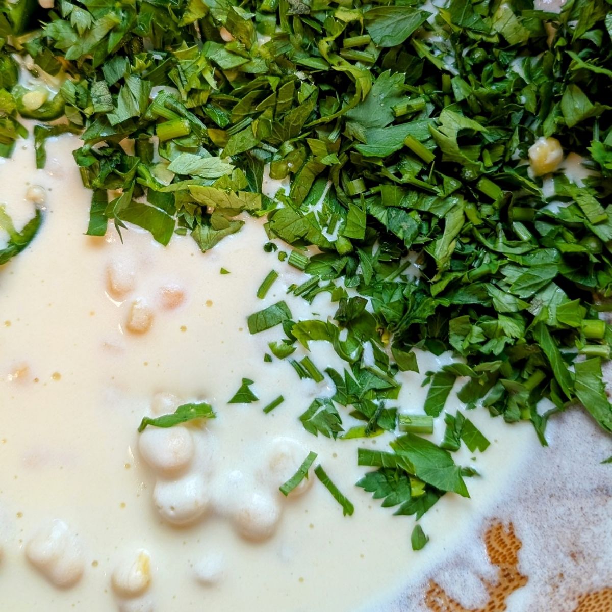 chopped cilantro corn bread mixture in a bowl to be mixed