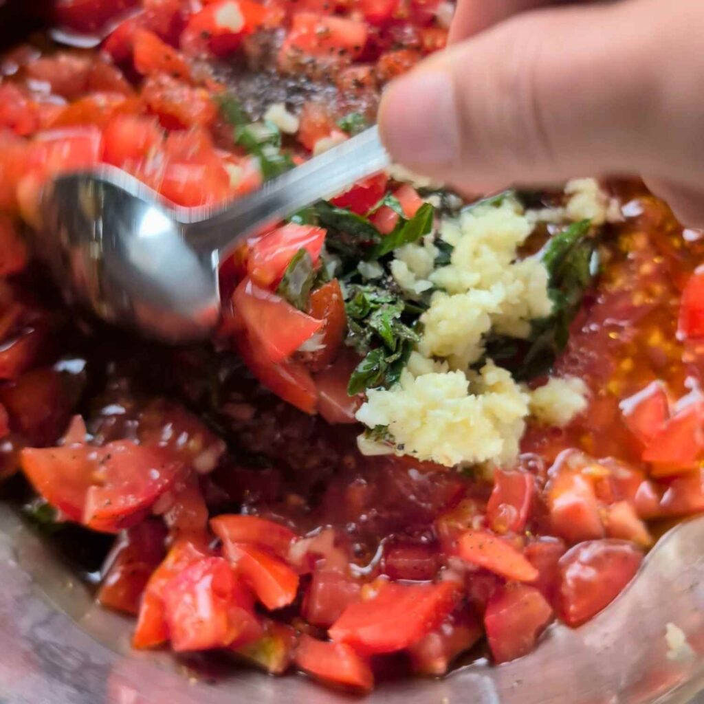 a and mixing ingredients for bruschetta sauce for an easy no cook appetizer sauce