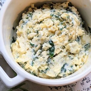 homemade garlic butter spread with fresh garlic cloves in a dish