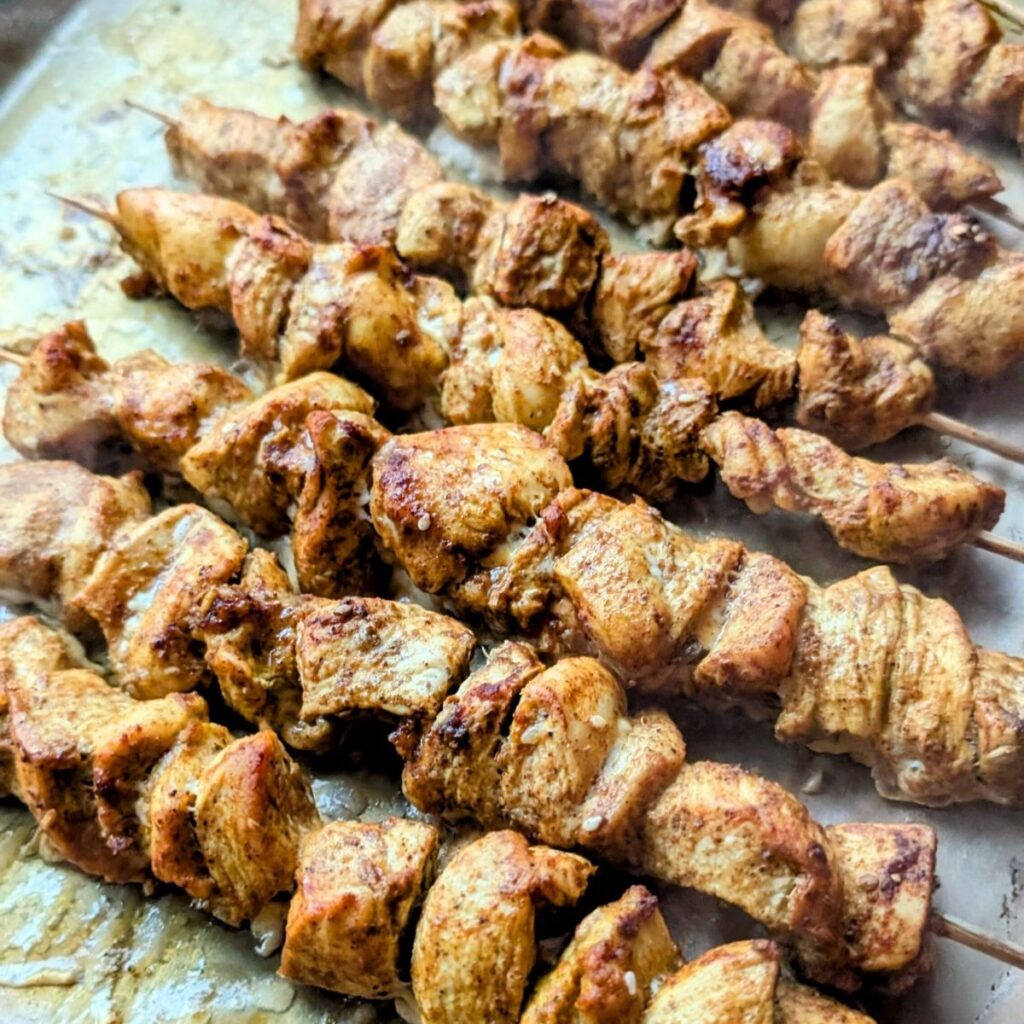 a baking sheet filled with chicken shawarma oven baked to perfection