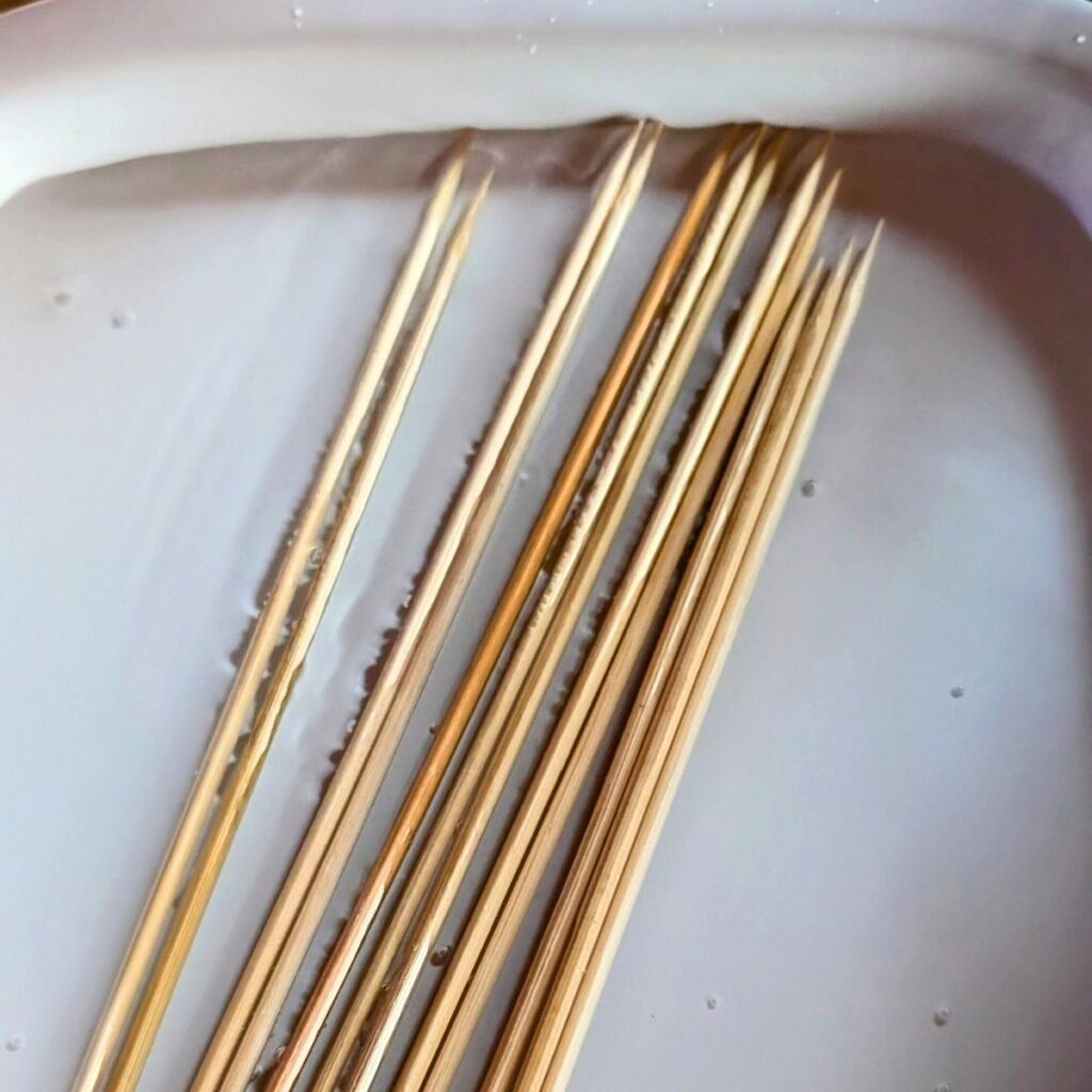 wooden skewers soaking in water so they don't burn in the oven.