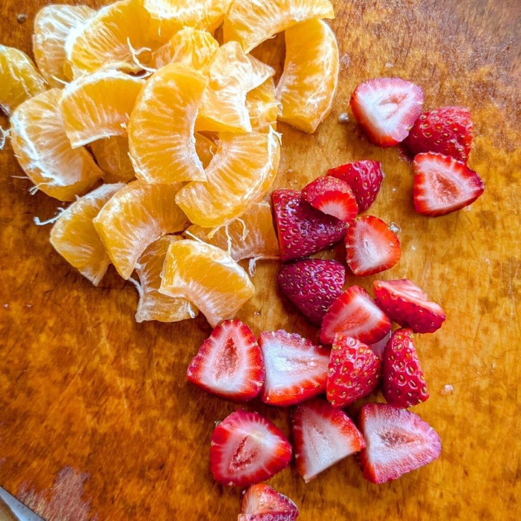 slice oranges and strawberries for summer sangria