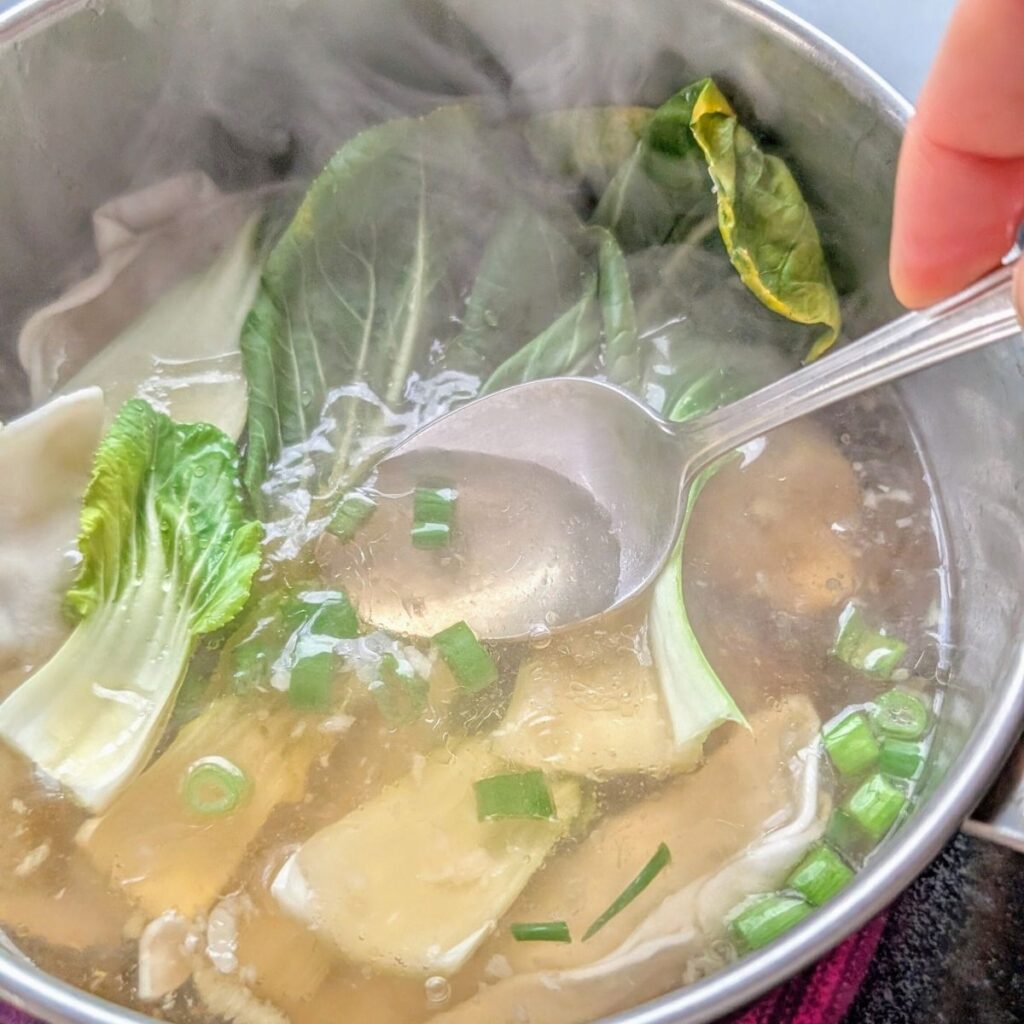 bok choy stirred into the soup to blanch the green leaves for a quick lunch idea.