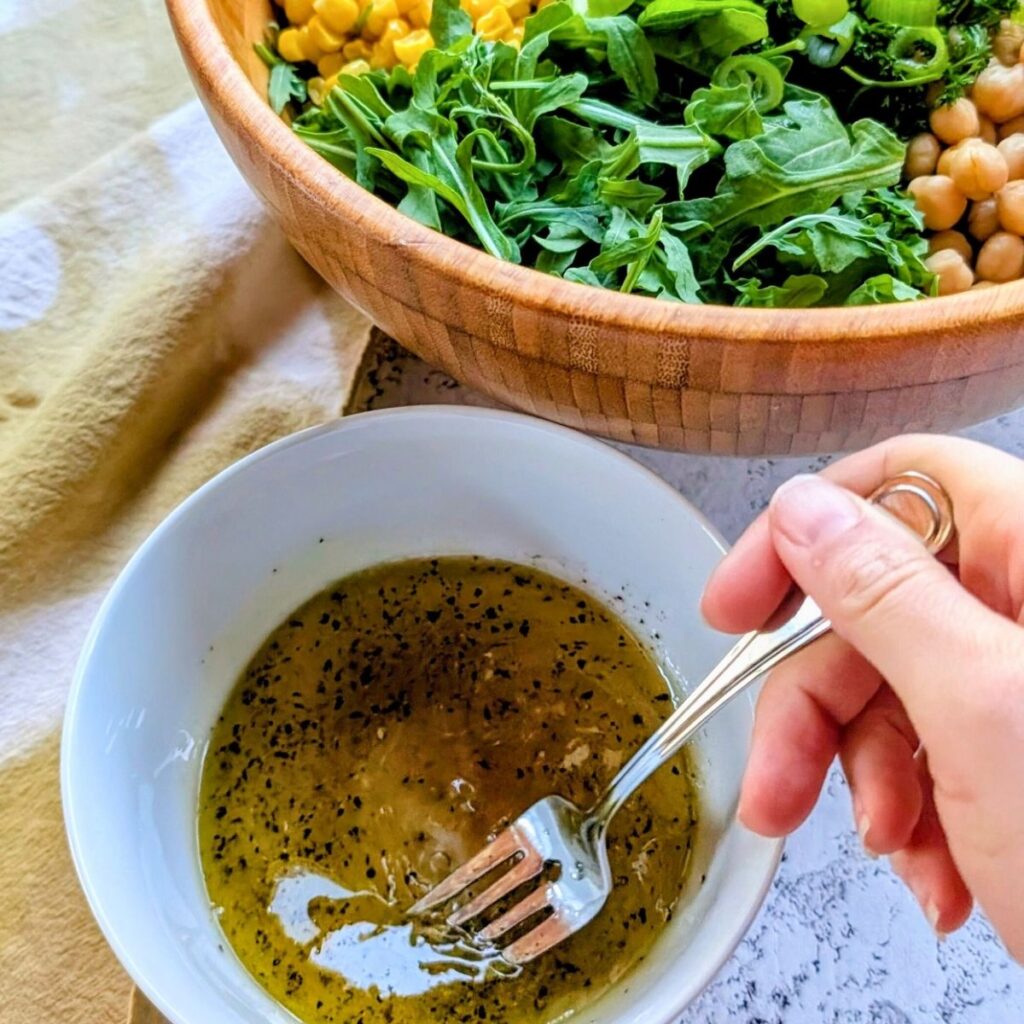 a small mixing bowl of pesto basil lemon dressing for a couscous salad.
