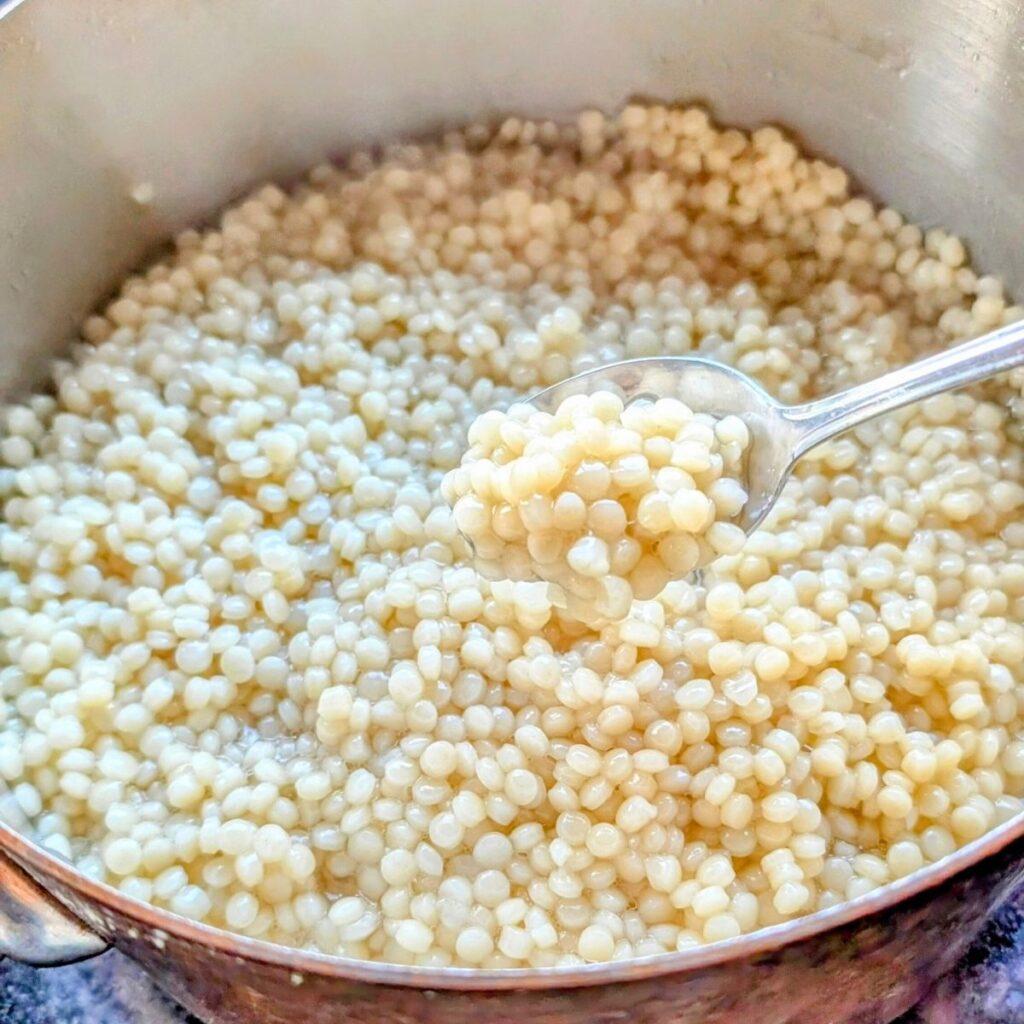 cooked couscous in a pot to make a salad with pearl couscous