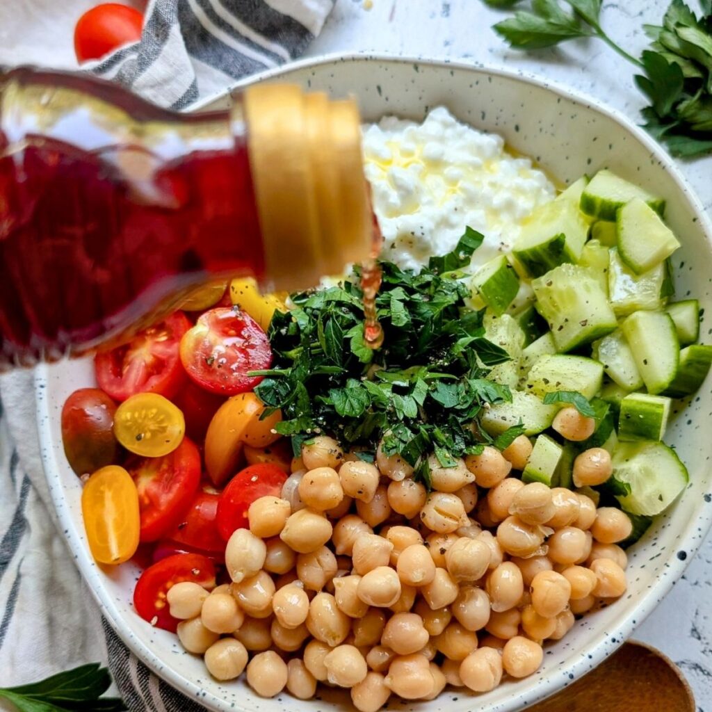 red wine vinegar drizzled over a vegetarian cottage cheese macro salad high in protein.