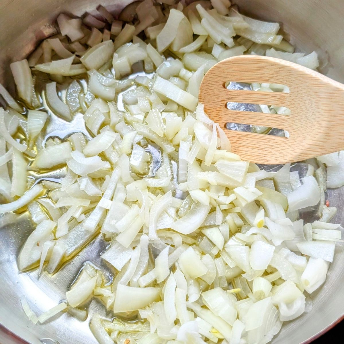 onions and garlic in a pot with olive oil to make penne alla vokda.