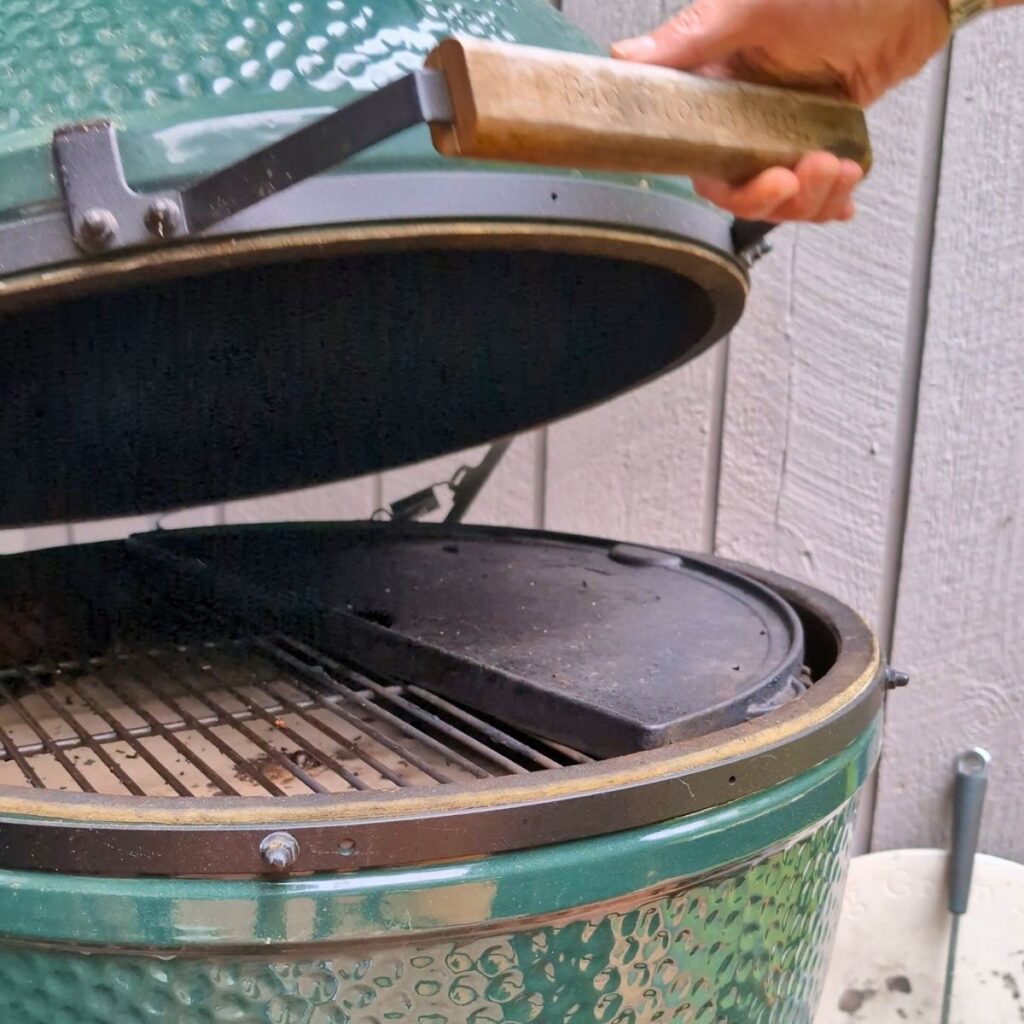 big green egg grill with a heat deflector and plancha grill pan