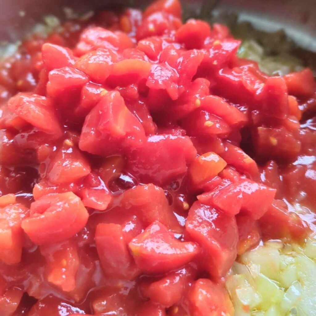 diced san marzano tomatoes into pasta sauce made with chorizo