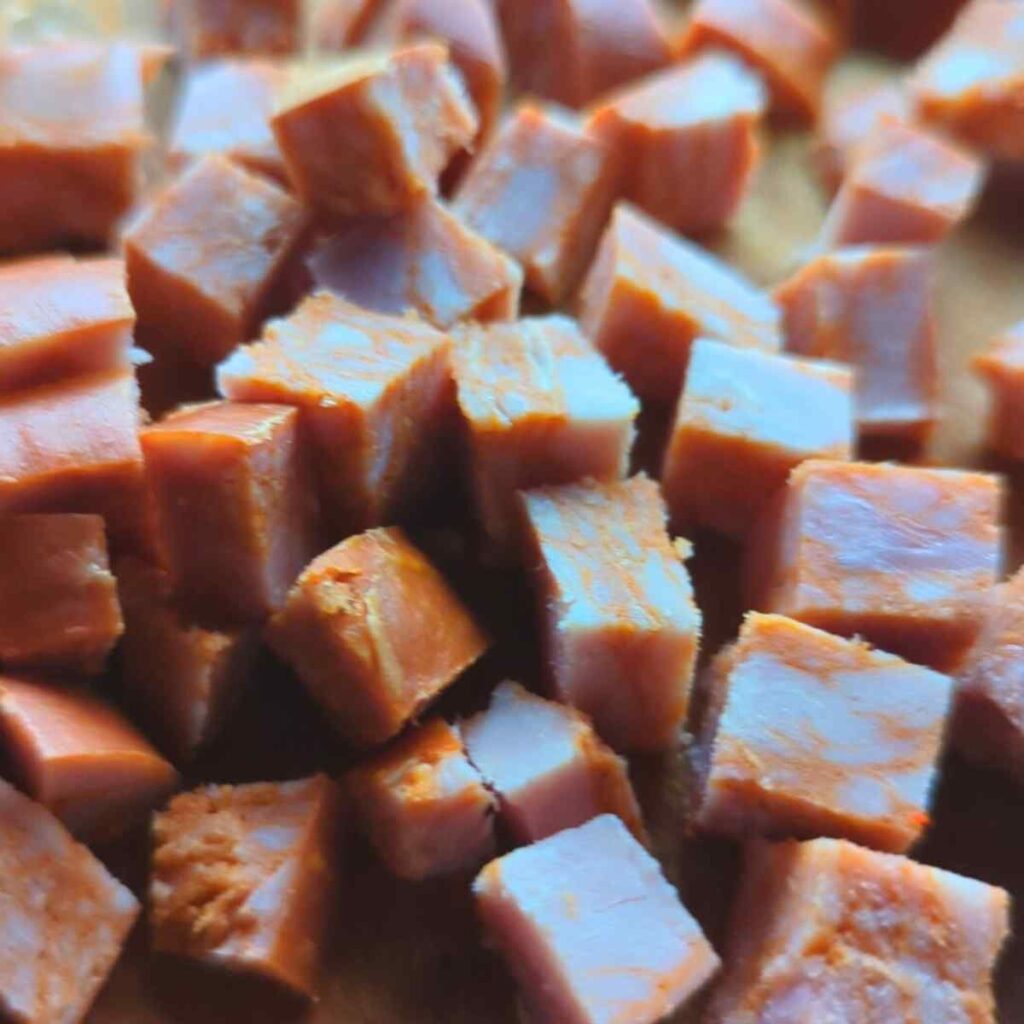 diced chorizo sausage on a cutting board ready to make pasta sauce.
