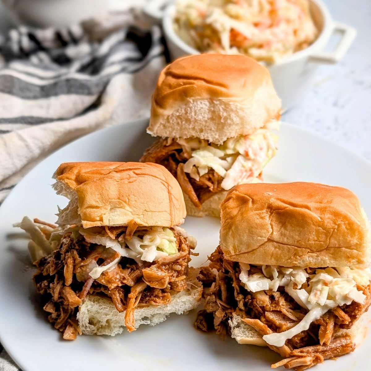 pulled pork chop sliders with coleslaw and hawaiian rolls for a modern dinner idea.