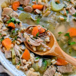 turkey farro soup with carrots, celery, onions, and parsley